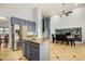 A kitchen with an island, blue cabinets, granite countertops, stainless steel appliances, and access to dining area at 2977 E County Down Dr, Chandler, AZ 85249