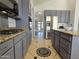 A kitchen featuring blue cabinets, granite countertops, stainless steel appliances, and decorative tile flooring at 2977 E County Down Dr, Chandler, AZ 85249