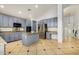 A kitchen features blue cabinets, granite countertops, stainless steel appliances, and a tiled floor at 2977 E County Down Dr, Chandler, AZ 85249