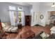 Airy living room with large windows, hardwood floors, and stylish furnishings at 2977 E County Down Dr, Chandler, AZ 85249