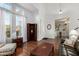 Bright living room with hardwood floors, corner shelving, and cozy seating at 2977 E County Down Dr, Chandler, AZ 85249