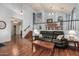 Inviting living room featuring wood floors, a staircase, and black leather sofa at 2977 E County Down Dr, Chandler, AZ 85249