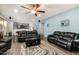 Open-concept living room featuring black leather sofas, fireplace, and pool table at 2977 E County Down Dr, Chandler, AZ 85249
