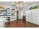 Spacious playroom with wood floors, ceiling fan, white cabinets and ample storage at 2977 E County Down Dr, Chandler, AZ 85249