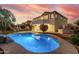 Beautiful backyard oasis with a sparkling pool and spa, surrounded by meticulously maintained landscaping at 2977 E County Down Dr, Chandler, AZ 85249