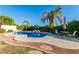 Inviting pool area with lush landscaping, patio seating, and a serene backyard setting at 2977 E County Down Dr, Chandler, AZ 85249