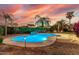 Inviting backyard pool with waterfall feature and lush landscaping, perfect for relaxing and entertaining at 2977 E County Down Dr, Chandler, AZ 85249