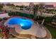 Inviting backyard oasis with a sparkling pool, rock waterfall, and manicured landscaping for relaxation at 2977 E County Down Dr, Chandler, AZ 85249