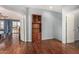 Room with wood floors, a display cabinet, and open doorways to other rooms at 2977 E County Down Dr, Chandler, AZ 85249