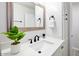 Bathroom featuring white quartz counters, modern black faucet, and cabinetry with sleek black hardware at 3517 E Monterosa St, Phoenix, AZ 85018