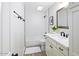 Modern bathroom featuring a skylight, white subway tile, and updated vanity with black fixtures at 3517 E Monterosa St, Phoenix, AZ 85018