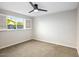 Well-lit bedroom features neutral carpet, fresh paint, and an open window with a view of the backyard at 3517 E Monterosa St, Phoenix, AZ 85018