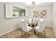 Bright dining area featuring modern light fixture, a glass table, and large windows at 3517 E Monterosa St, Phoenix, AZ 85018