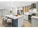 Bright kitchen with a center island, stainless steel appliances, white cabinets, and a modern design at 3517 E Monterosa St, Phoenix, AZ 85018