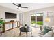 Cozy living room with a TV, modern furniture, a ceiling fan, and access to the backyard at 3517 E Monterosa St, Phoenix, AZ 85018