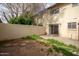Private backyard with sliding glass door and a stone block path at 3605 W Bethany Home Rd # 7, Phoenix, AZ 85019