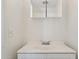 A white bathroom offers a modern sink vanity, updated lighting, and neutral paint at 3605 W Bethany Home Rd # 7, Phoenix, AZ 85019