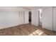 Spacious bedroom with wood-look tile flooring, closet and bathroom access at 3605 W Bethany Home Rd # 7, Phoenix, AZ 85019