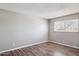 Empty bedroom showcasing a window for natural light, and wood floors at 3605 W Bethany Home Rd # 7, Phoenix, AZ 85019