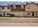 Modest townhouse featuring a tidy front lawn and classic architectural details at 3605 W Bethany Home Rd # 7, Phoenix, AZ 85019