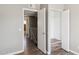 Hallway featuring a closet organizer, access to the bathroom, and modern vinyl flooring at 3605 W Bethany Home Rd # 7, Phoenix, AZ 85019