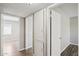 Hallway featuring neutral paint colors, hard surface floors, and white doors at 3605 W Bethany Home Rd # 7, Phoenix, AZ 85019