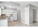 Bright kitchen featuring a set of white appliances, light countertops, and white cabinetry at 3605 W Bethany Home Rd # 7, Phoenix, AZ 85019