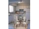 Bright kitchen with all-white appliances and cabinetry, paired with a cozy dining area at 3605 W Bethany Home Rd # 7, Phoenix, AZ 85019
