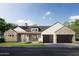 Contemporary home featuring a stone accents, dark garage doors, and a well-manicured lawn at 3743 E Hazelwood St, Phoenix, AZ 85018