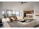 Bright open concept living room with hardwood floors, modern furnishings, and large sliding glass doors to outdoors at 3743 E Hazelwood St, Phoenix, AZ 85018