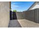 Gated side yard with gravel, surrounded by a dark block fence at 4165 E Huntington Dr, Phoenix, AZ 85040
