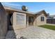 Paver patio and a touch of green artificial turf with double doors leading into home at 4165 E Huntington Dr, Phoenix, AZ 85040
