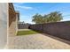 Paver patio with artificial turf in a private backyard, enclosed by a tall block fence at 4165 E Huntington Dr, Phoenix, AZ 85040