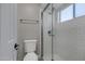 Bathroom featuring a toilet and a walk-in shower with white subway tile behind a glass door at 4165 E Huntington Dr, Phoenix, AZ 85040
