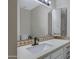 Bathroom vanity with modern faucet, white countertop, decorative backsplash, and framed mirror at 4165 E Huntington Dr, Phoenix, AZ 85040