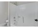 Clean, white bathtub and shower combination featuring a shower head, faucet, and hand grip at 4165 E Huntington Dr, Phoenix, AZ 85040