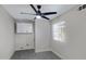 Cozy bedroom with wood-look flooring, ceiling fan, and bright window at 4165 E Huntington Dr, Phoenix, AZ 85040