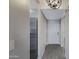 Hallway with gray wood-look tile and a view of the white front door and GE stainless steel refrigerator at 4165 E Huntington Dr, Phoenix, AZ 85040