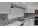 Beautiful kitchen features granite countertops, stainless appliances, and crisp white cabinetry at 4165 E Huntington Dr, Phoenix, AZ 85040