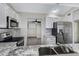 Open kitchen featuring white cabinets, stainless steel appliances, and granite countertops at 4165 E Huntington Dr, Phoenix, AZ 85040