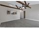 Spacious living room featuring exposed ceiling beams and a passthrough to the kitchen at 4165 E Huntington Dr, Phoenix, AZ 85040