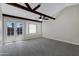 Bright sun room with a ceiling fan, exposed ceiling beams, and double doors to the backyard at 4165 E Huntington Dr, Phoenix, AZ 85040