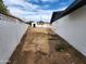 View of the backyard with a dirt area, shed and block fencing on the property at 4210 W Solano Dr, Phoenix, AZ 85019