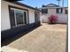 Backyard with white walls, gravel and a bright pink flowering bush at 4210 W Solano Dr, Phoenix, AZ 85019