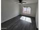 Bedroom featuring hardwood flooring, a ceiling fan, and a window at 4210 W Solano Dr, Phoenix, AZ 85019