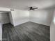 An open bedroom with grey hardwood flooring and a ceiling fan at 4210 W Solano Dr, Phoenix, AZ 85019