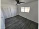 Bedroom featuring hardwood flooring, a ceiling fan, and ample closet space at 4210 W Solano Dr, Phoenix, AZ 85019