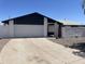 Home exterior featuring a white garage door and monochromatic color scheme with low maintenance desert landscaping at 4210 W Solano Dr, Phoenix, AZ 85019