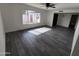 The living room features updated gray flooring, a modern ceiling fan and ample natural light at 4210 W Solano Dr, Phoenix, AZ 85019