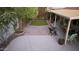 Well-maintained backyard with covered patio, artificial grass, stone pavers, and privacy fencing at 441 E Encinas Ave, Gilbert, AZ 85234